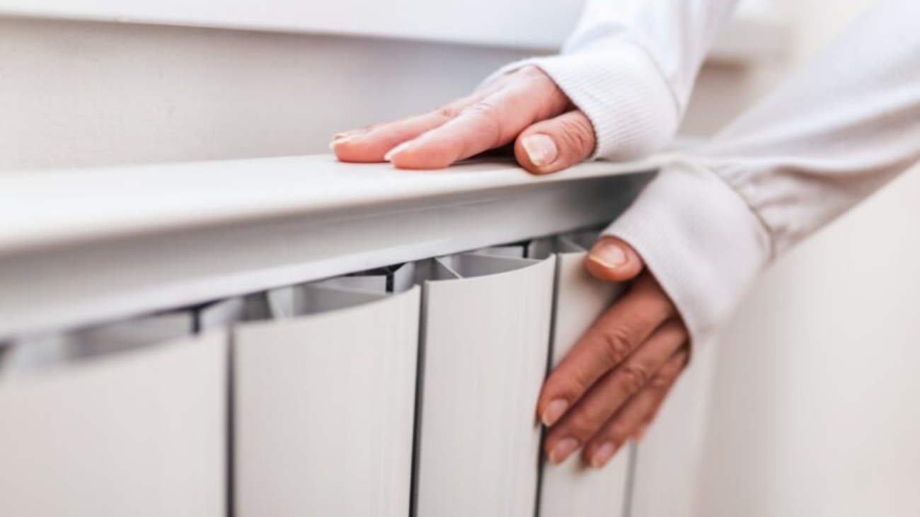 heavy-duty-radiator-central-heating-woman-is-getting-her-hands-warm-on-home-central-heating-system-min