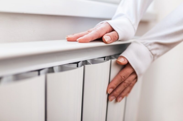 heavy-duty-radiator-central-heating-woman-is-getting-her-hands-warm-on-home-central-heating-system-min